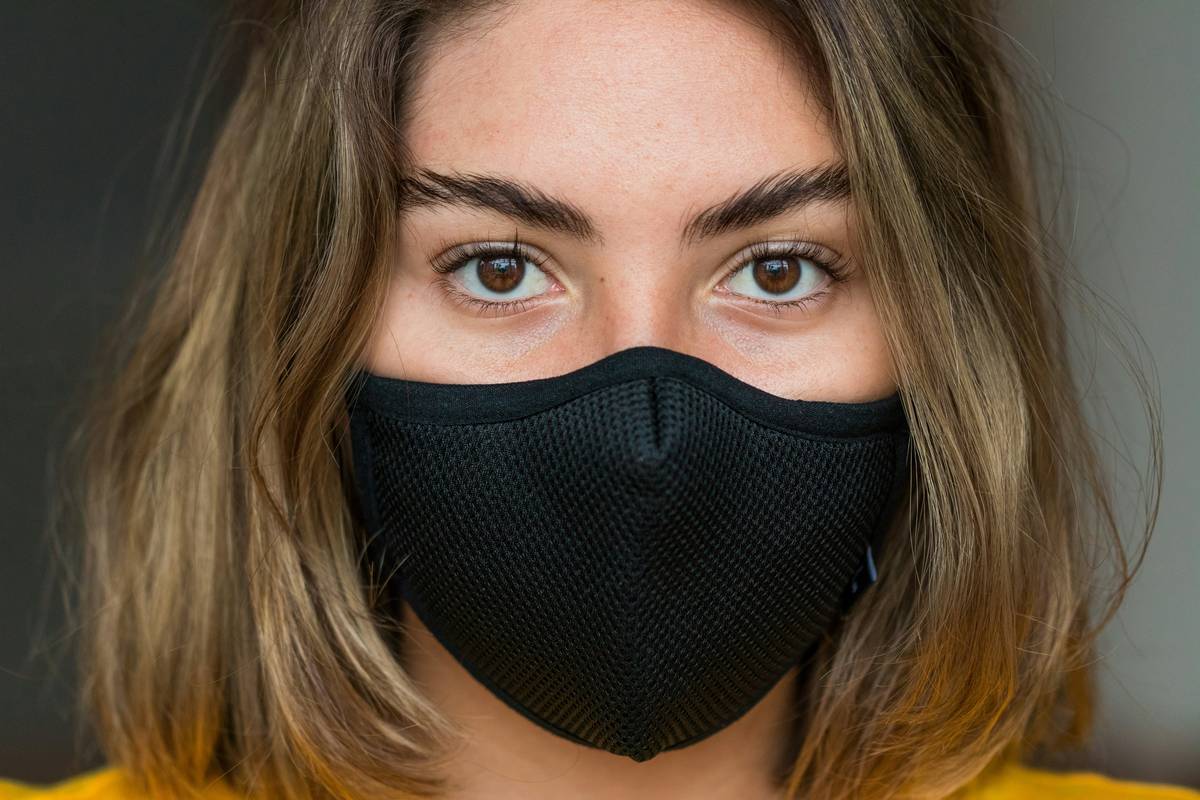 Woodworker wearing woodworking dust masks reusable while sanding maple wood