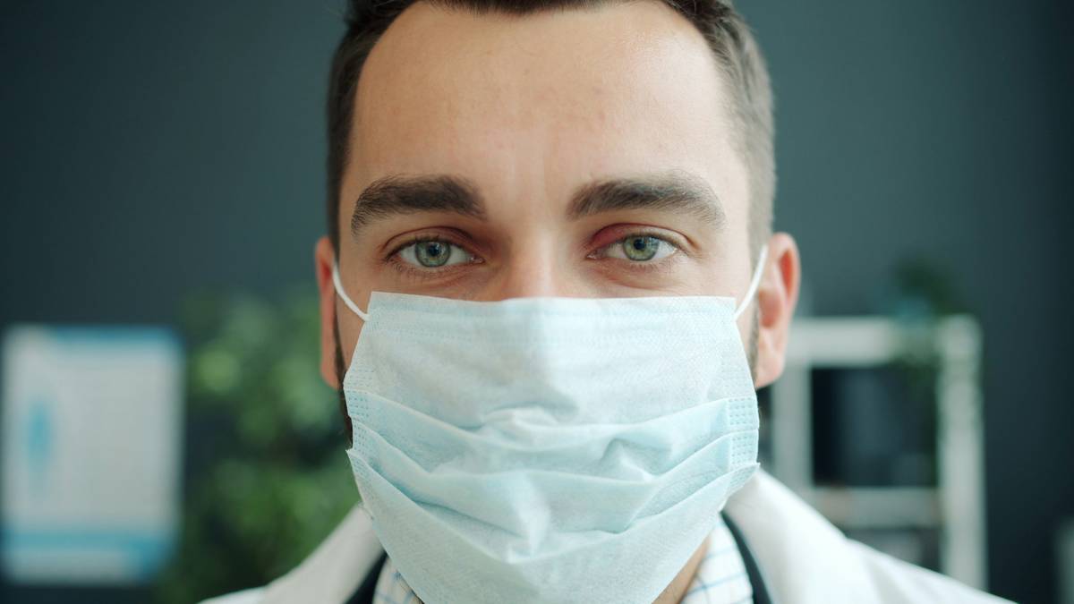 CDC face masks for healthcare workers being washed in a sink with mild detergent and laid flat to dry on a clean towel